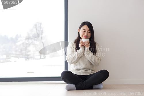 Image of asian woman enjoying morning coffee