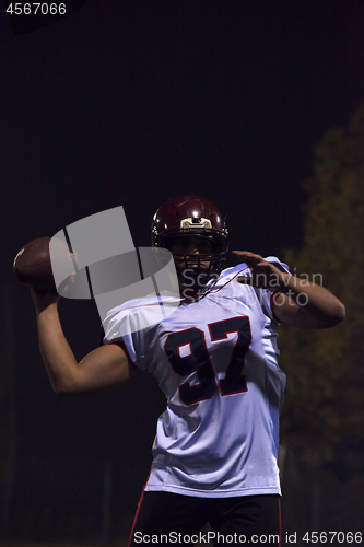 Image of american football player throwing rugby ball