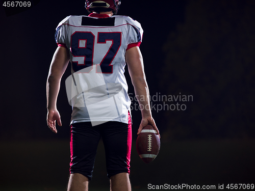 Image of rear view of young confident American football player