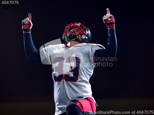 Image of american football player celebrating after scoring a touchdown