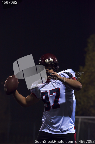 Image of american football player throwing rugby ball