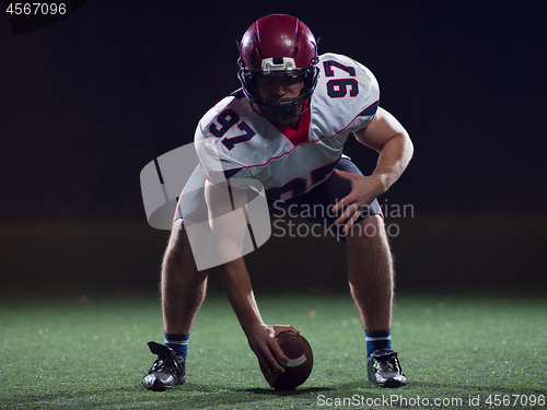 Image of American football player starting football game