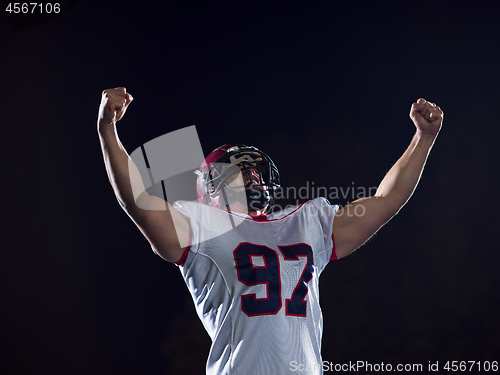 Image of american football player celebrating after scoring a touchdown