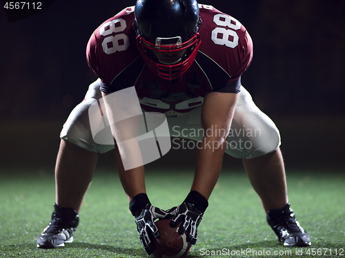 Image of American football player starting football game