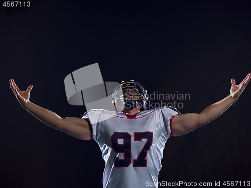 Image of american football player celebrating after scoring a touchdown