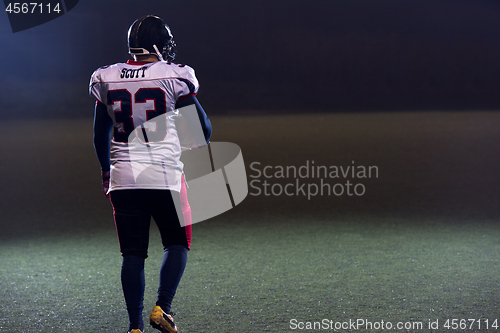 Image of rear view of young confident American football player