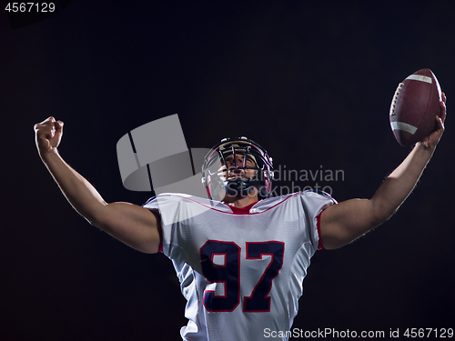 Image of american football player celebrating after scoring a touchdown