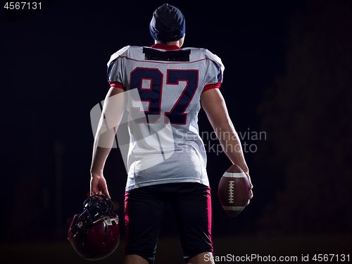 Image of rear view of young confident American football player