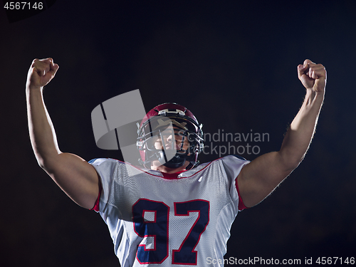 Image of american football player celebrating after scoring a touchdown