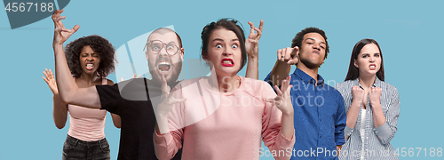 Image of The young emotional angry and scared men and women standing and looking at camera