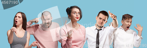 Image of Beautiful male and female half-length portrait isolated on blue studio backgroud. The young emotional surprised men and women