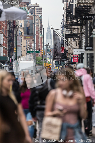 Image of New York, NY, USA - May 17, 2018: Crowds of people walking sidewalk of Broadway avenue in Soho of Midtown Manhattan on may 17th, 2018 in New York City, USA.