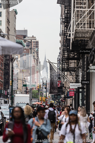 Image of New York, NY, USA - May 17, 2018: Crowds of people walking sidewalk of Broadway avenue in Soho of Midtown Manhattan on may 17th, 2018 in New York City, USA.