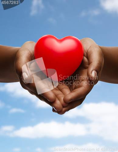 Image of female hands with small red heart