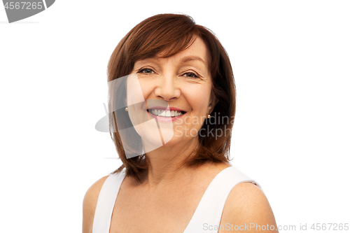 Image of portrait of smiling senior woman over white