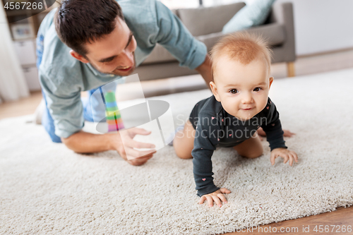 Image of happy little baby girl with father at home