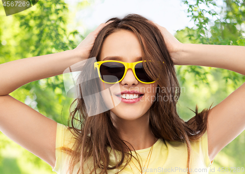 Image of teenage girl in yellow sunglasses and t-shirt