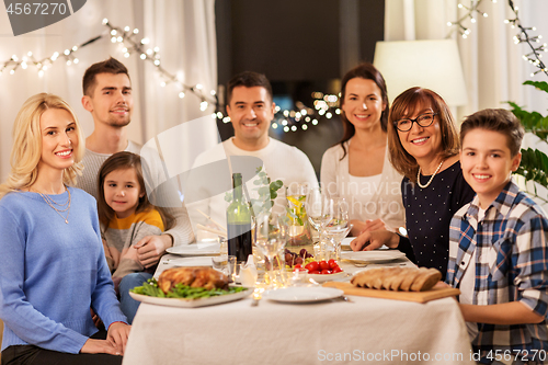 Image of happy family having dinner party at home