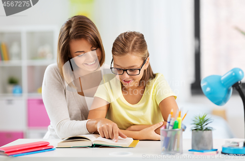 Image of mother and daughter doing homework together