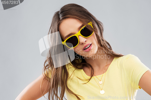 Image of teenage girl in yellow sunglasses and t-shirt