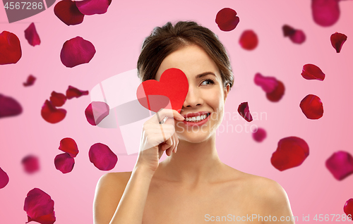 Image of beautiful smiling woman holding red heart