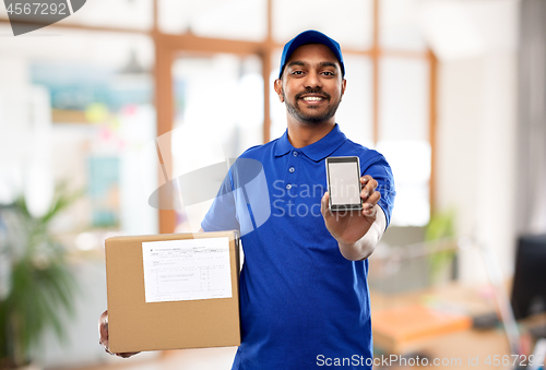 Image of indian delivery man with smartphone and parcel box