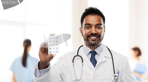 Image of indian male doctor with pills and stethoscope