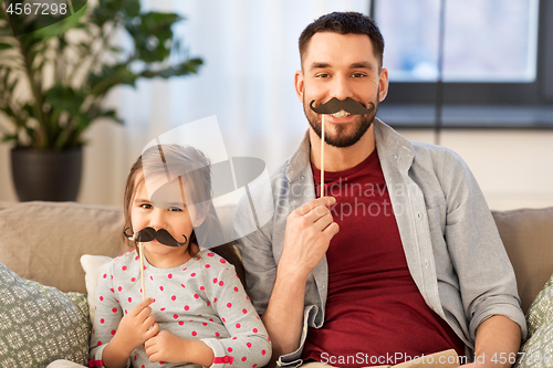 Image of father and daughter with mustaches having fun