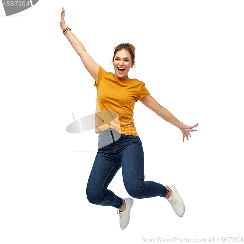 Image of happy young woman or teenage girl jumping