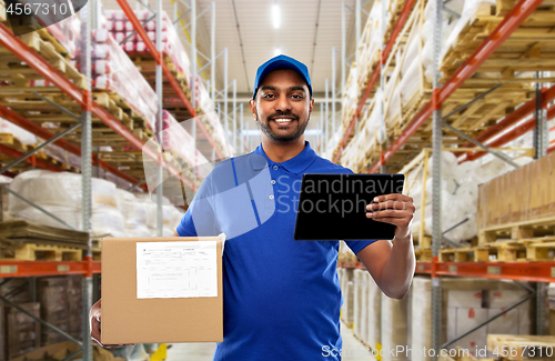 Image of delivery man with tablet pc and box at warehouse