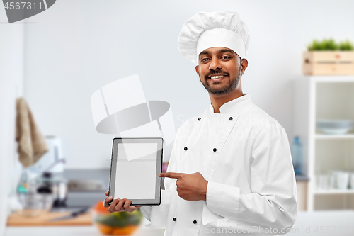 Image of happy indian chef with tablet computer at kitchen