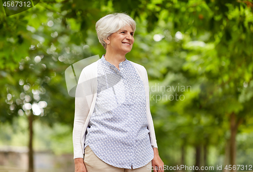 Image of happy senior woman at summer park