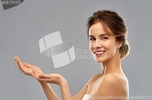 Image of smiling young woman holding something imaginary