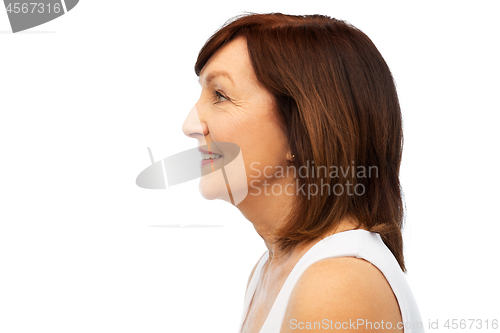 Image of profile of smiling senior woman over white