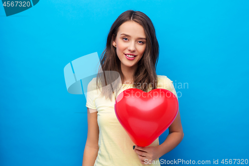 Image of teenage girl with red heart-shaped balloon