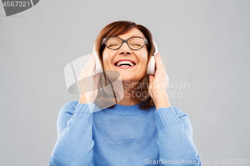 Image of senior woman in headphones listening to music