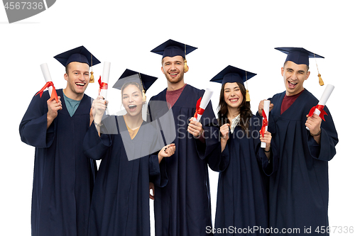 Image of graduates in mortar boards with diplomas