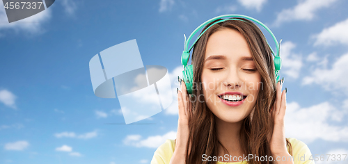 Image of happy young woman or teenage girl with headphones