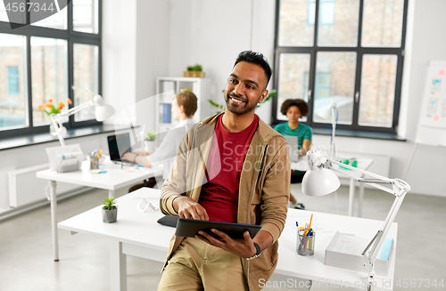 Image of indian man with tablet pc computer at office