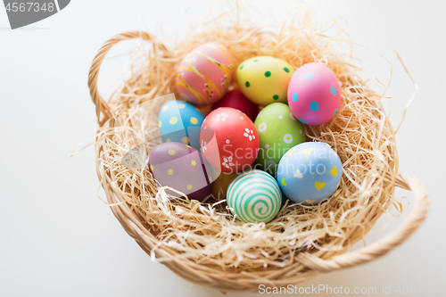 Image of close up of colored easter eggs in basket