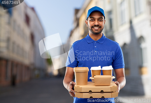 Image of indian delivery man with food and drinks in city