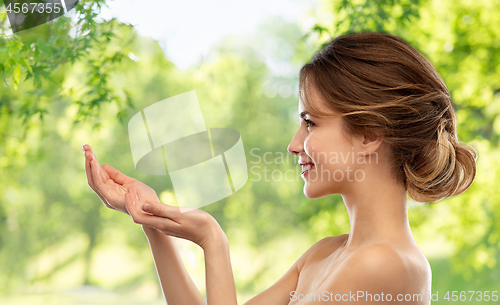 Image of smiling young woman holding something imaginary