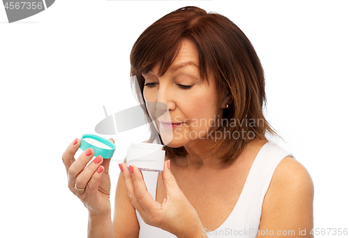 Image of senior woman with cream jar