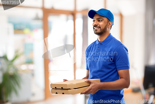 Image of indian delivery man with takeaway pizza at office