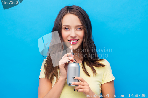 Image of young woman or teenage girl drinking soda from can