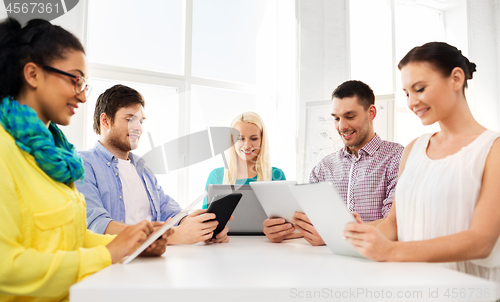 Image of creative team with table computers in office