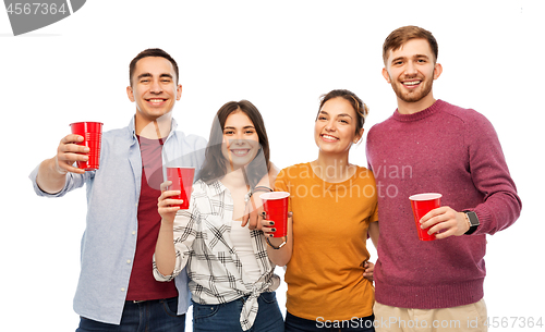 Image of group of smiling friends with drinks in party cups