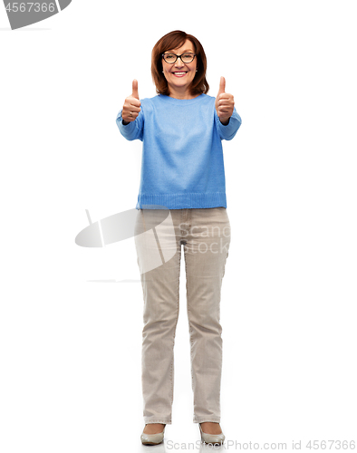 Image of happy smiling senior woman showing thumbs up