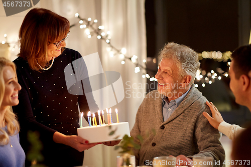 Image of happy family having birthday party at home