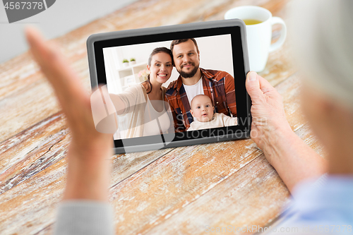 Image of family having video call on tablet computer